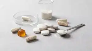 Food supplement tablets with capsules, gummies and powder shown as common supplement dosage forms