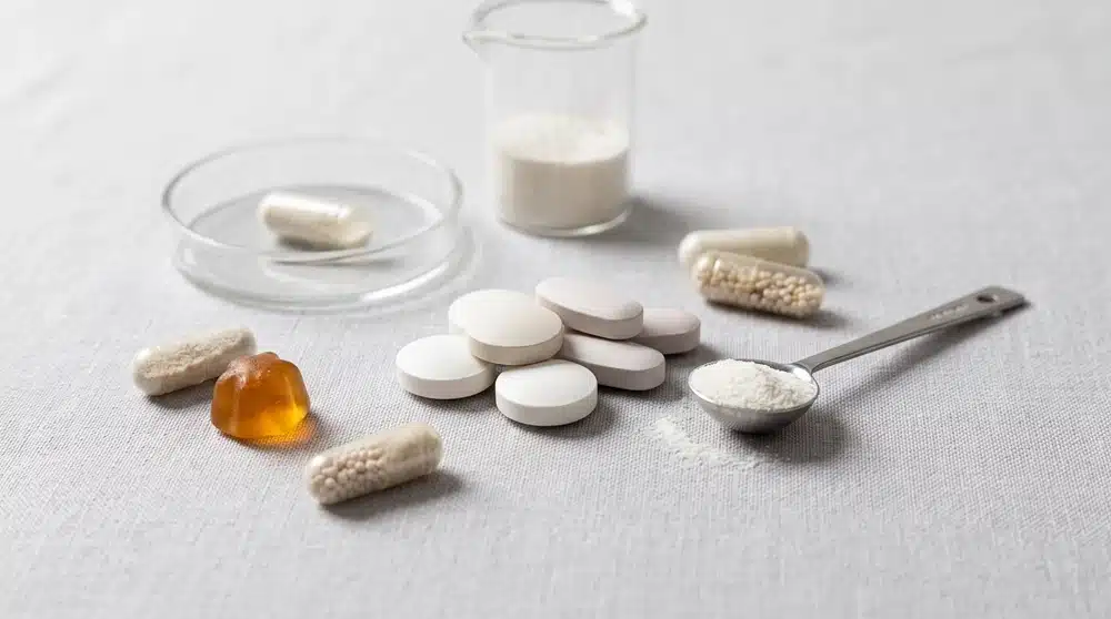 Food supplement tablets with capsules, gummies and powder shown as common supplement dosage forms