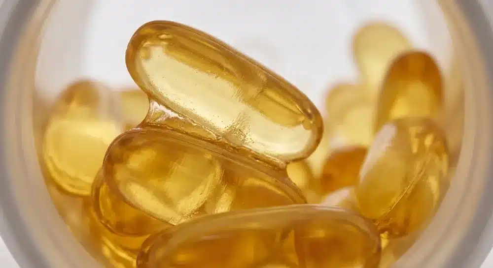 Close-up of fish oil softgels sticking together after exposure to unsuitable heat or humidity